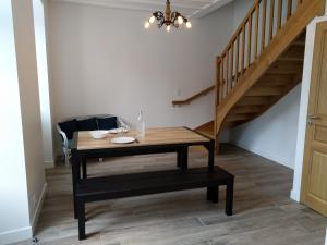 a dining room with a table and a staircase at Etape cyclo- rando sur la VéloFrancette in Montflours