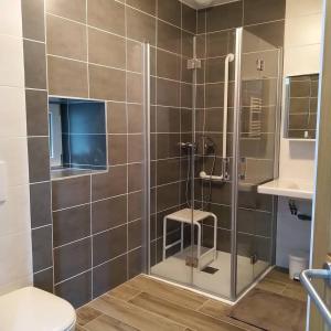 a bathroom with a shower with a stool in it at Etape cyclo- rando sur la VéloFrancette in Montflours