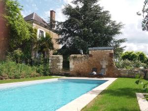 a swimming pool in front of a house at L'ecole des Filles in Poncé sur Le Loir