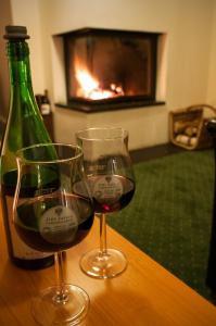 two glasses of wine and a bottle on a table at LIHO - einfach Lübeck in Lübeck