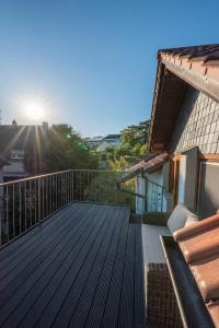 a balcony of a house with a wooden deck at Ferienhaus bis 10 Personen und 2,5 Schlafzimmern in Geisenheim