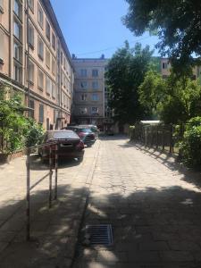 a street with cars parked on the side of the road at Widok Kielce in Kielce