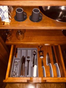 a drawer with utensils in a wooden cabinet at Castle of Glamour XVI century Luxury Apartments in Rome