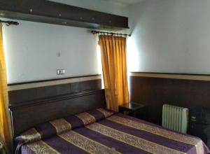 Un pat sau paturi într-o cameră la GMVN Auli