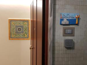 a bathroom door with a sign on a tiled wall at RosAmar in Bari