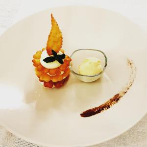 a plate with a pineapple dessert and a stick of butter at Borgo Lu Puleu in Perfugas