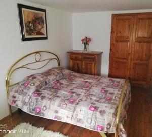 a bedroom with a bed with a quilt on it at Clou Accomodation in Aosta