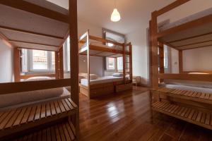 two bunk beds in a room with wooden floors at Inn Possible Lisbon Hostel in Lisbon