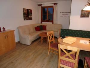 a living room with a couch and a table at Tischlergut in Leogang