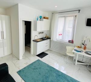 a white kitchen with a table and a dining room at Casa T&G apartment, near Siena, in Chianti, Tuscany in Siena