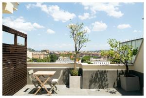 a balcony with a table and a view of the city at 5-Rooms Apartment in Rome