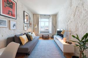 a living room with a couch and a table at Cativo Apartment - Porto Downtown in Porto