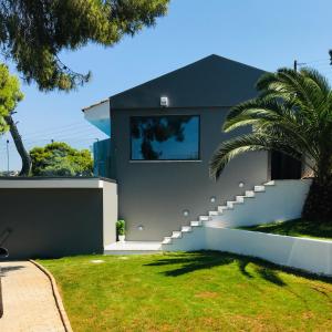 a house with a staircase in a yard at Villa tranquility in Lagonissi