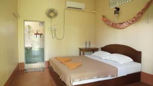 A bed or beds in a room at Coconut Guest House