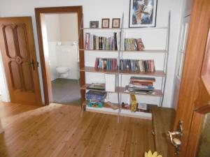 a room with a book shelf filled with books at Landhaus am Bach in Winterberg