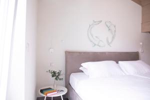 A bed or beds in a room at CHARMING MOMENT di Villa Porta - Residenza Porto Vecchio