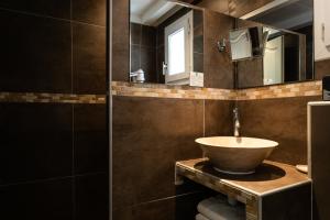 a bathroom with a sink and a mirror at Le Mas de Cocagne in Saintes-Maries-de-la-Mer