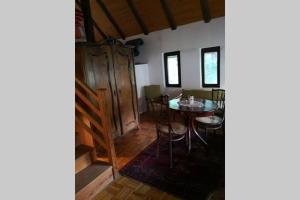 a dining room with a table and chairs at Cherry Tree Villa in Bošnjaci