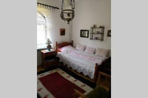 a bedroom with a bed and a desk and a window at Cherry Tree Villa in Bošnjaci