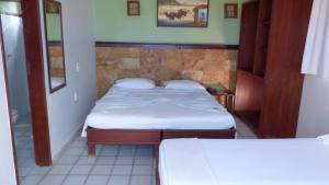 
A bed or beds in a room at Bella Natal Praia Hotel
