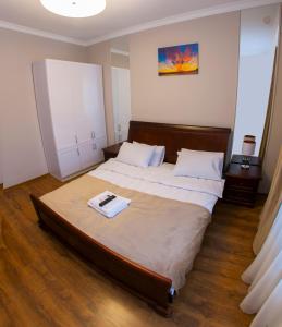 a bedroom with a large bed with two white pillows at Embrace in Truskavets