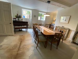 a kitchen with a table, chairs, and a sink at Baye House in Colchester