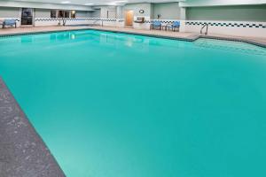 a large swimming pool in a hotel room at La Quinta by Wyndham Logan in Logan