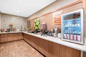 a fast food restaurant with a counter with a refrigerator at La Quinta by Wyndham Logan in Logan