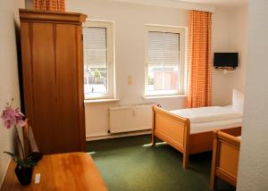 En eller flere senge i et værelse på Hotel Meiendorfer Park