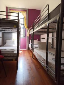 two bunk beds in a small room at By Doors Hostel in Porto
