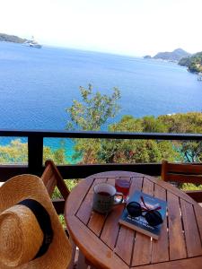 a wooden table with a book and a cup of coffee on it at Guest House Matana in Sobra