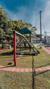 a playground with a slide in a park at La Ville Residence in Florianópolis