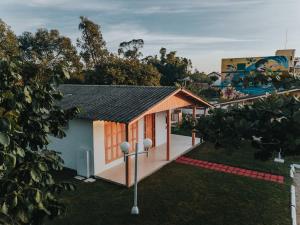 a small house with a black roof at La Ville Residence in Florianópolis