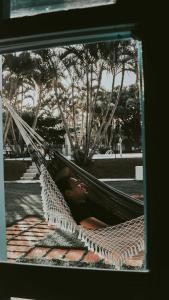 a woman laying in a hammock in a park at La Ville Residence in Florianópolis