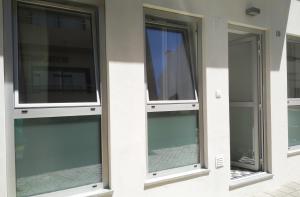 three windows on the side of a building at Apartamentos Areia e Mar Sul in Vila Praia de Âncora