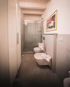 a bathroom with a toilet and a sink and a shower at La Loggia in Chiavenna