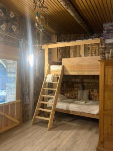 a room with two bunk beds in a room at L’allée des peupliers in Chevigny