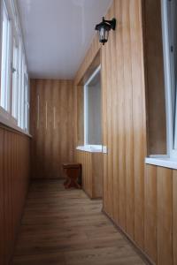 a hallway with wood paneled walls and a window at Comfortable Apartments in Kryvyi Rih