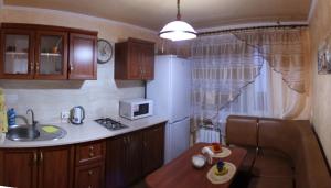a small kitchen with a sink and a microwave at Comfortable Apartments in Kryvyi Rih