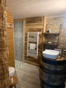 a bathroom with a barrel sink and a toilet at L’allée des peupliers in Chevigny