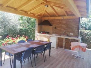 a patio with a table and chairs and a kitchen at Apartments Mirela in Poreč