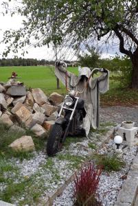 a motorcycle parked next to a pile of rocks at Urlauben, da wo der Geist wohnt in Eging
