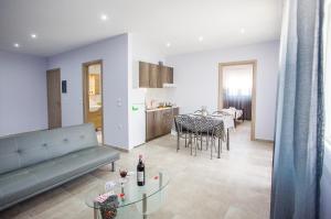a living room with a couch and a table at Kaiafas Luxury Philoxenia in Nea Peramos
