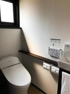 a bathroom with a white toilet and a sink at Saigawa House in Kanazawa