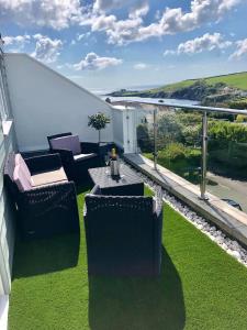 a room with a table, chairs, and an umbrella at Tremarne Hotel in Mevagissey