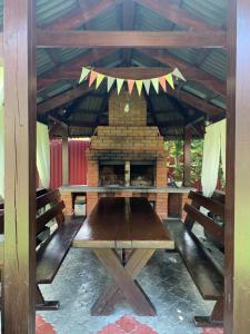 a picnic table in a pavilion with a fireplace at Августин in Solochyn