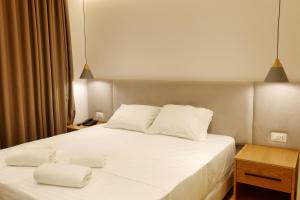 Postel nebo postele na pokoji v ubytování NOI HOTEL