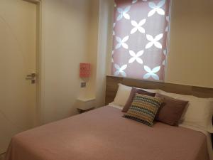 a bedroom with a bed and a window with butterflies on it at RosAmar in Bari