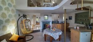 a kitchen and dining room with a table in a room at The Burren Barn in Tubber