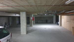 an empty parking garage with a car parked in it at Apartman Sweet dreams 2 in Niš